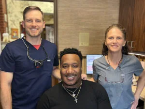 Dr. Till and staff smiling with a patient at Georgia Dental Studio