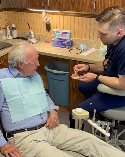 Dr. Till discussing a restorative dentistry procedure to a patient