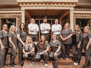 the Georgia Dental Studio team posing in front of their office