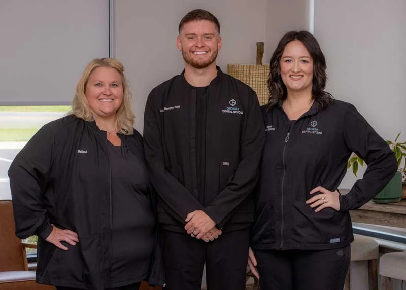 The dedicated team at Georgia Dental Studio getting ready to discuss dental crowns with a patient at Georgia Dental Studio.