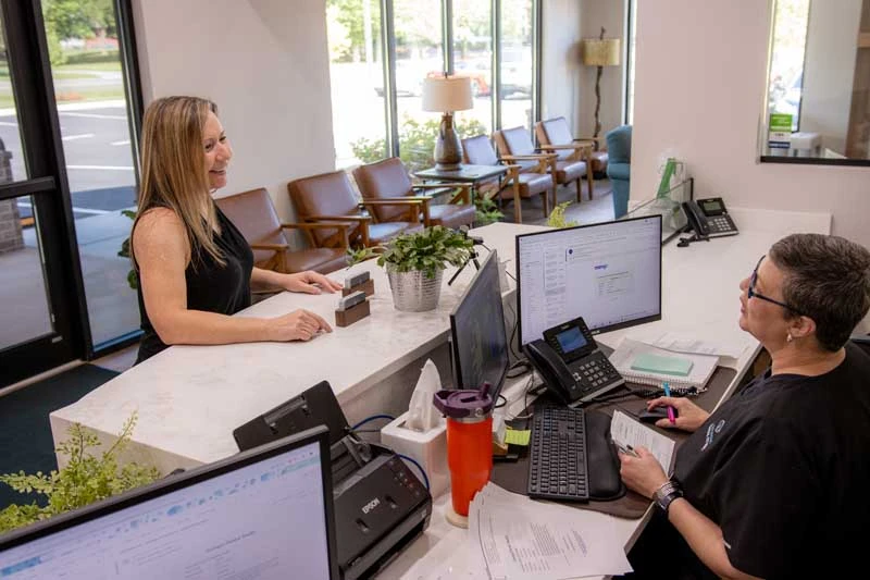 Patient discussing preventative treatment options with the front desk at Georgia Dental Studio.