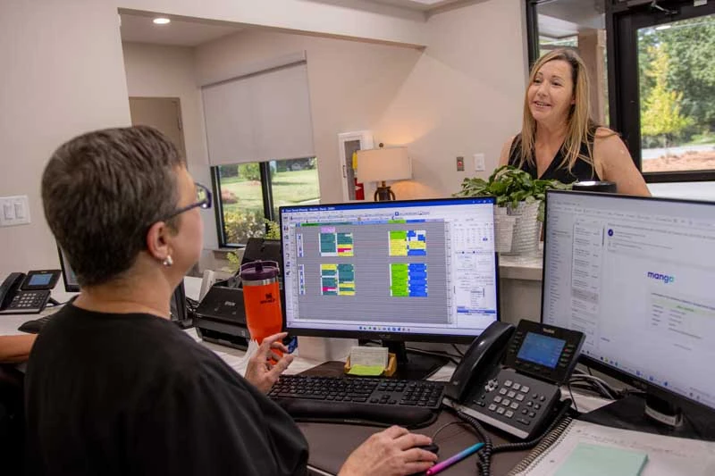 A patient checking in at the font desk before a restorative procedure.