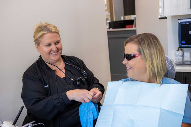 Patient and staff member getting ready for a teeth whitening at Georgia Dental Studio. 