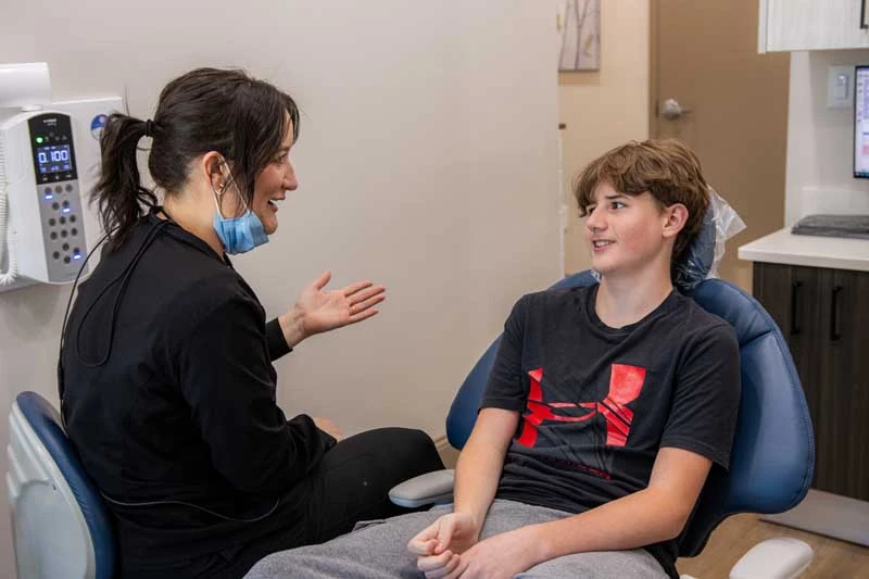 Young patient discussing clear aligner options with the friendly staff at Georgia Dental Studio. 